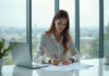 Femme d'affaires signant un contrat de prêt dans un bureau lumineux
